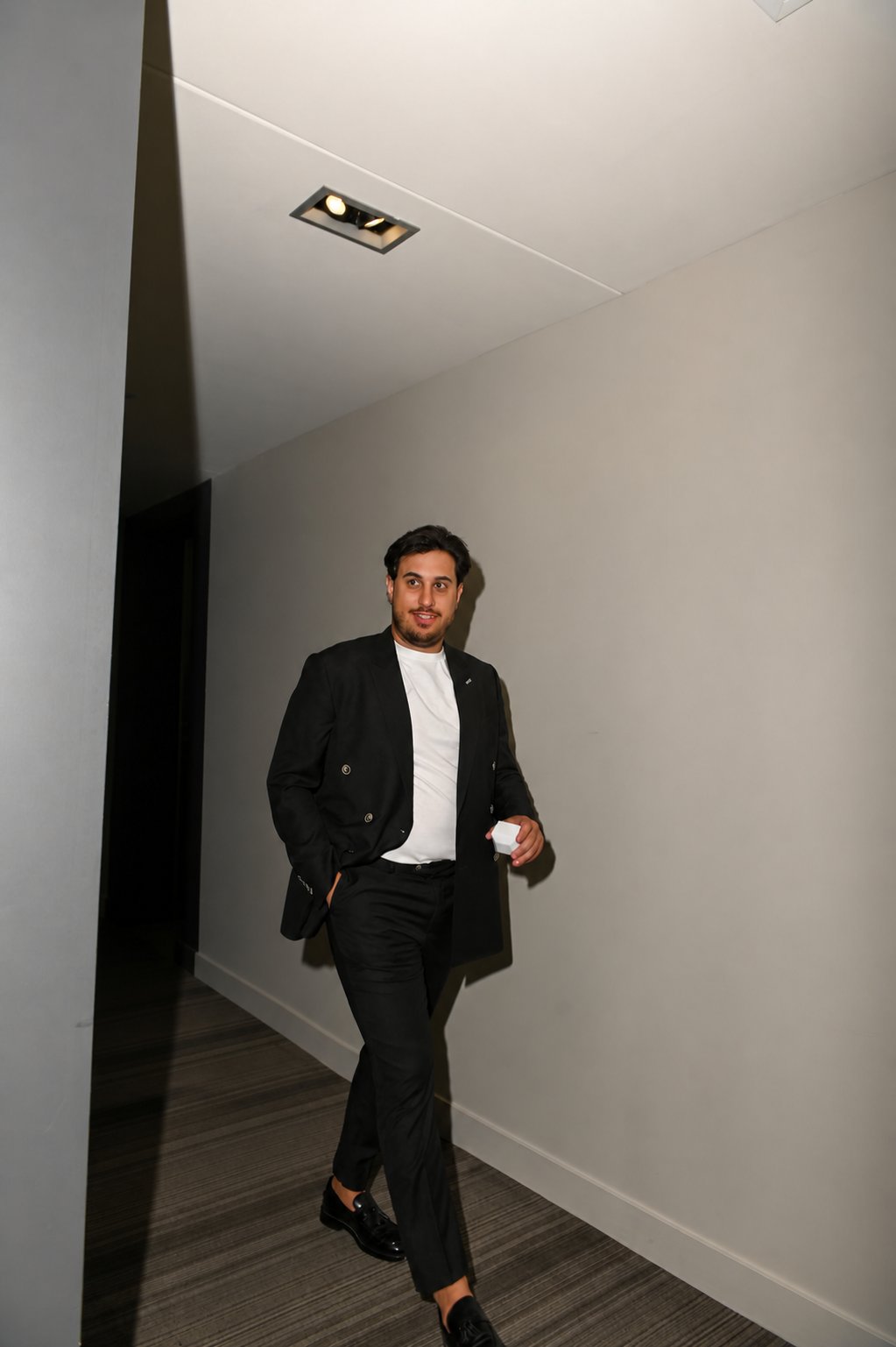 Anthony Delli Fraine walking through a contemporary Montreal residence